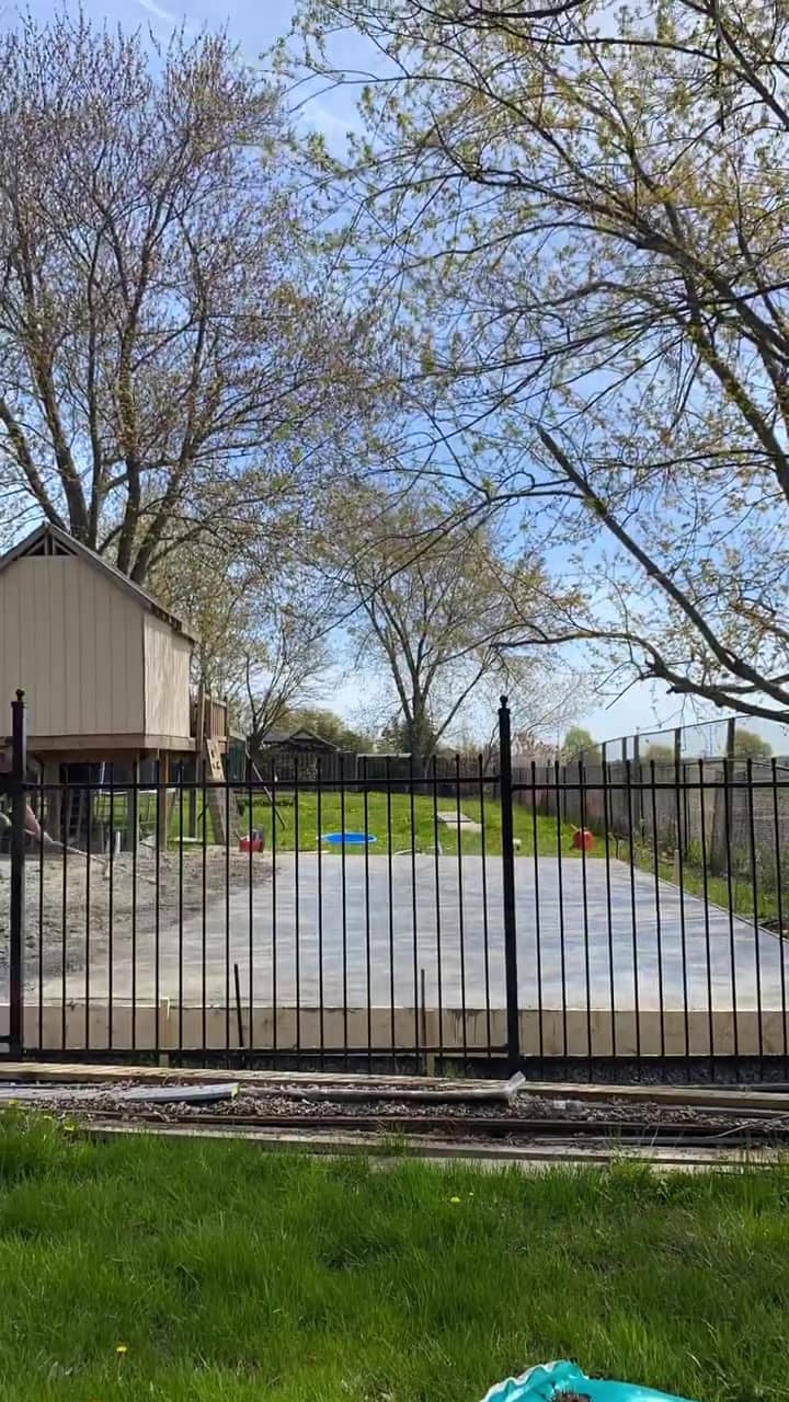 Broom finish concrete basketball pad in a backyard