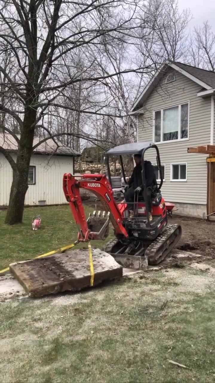 Mini excavator on an interlock job site