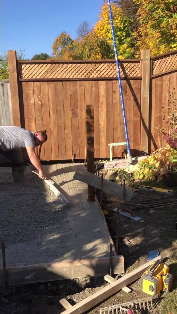 Fresh concrete being screeded and finished on a walkway in Dundas